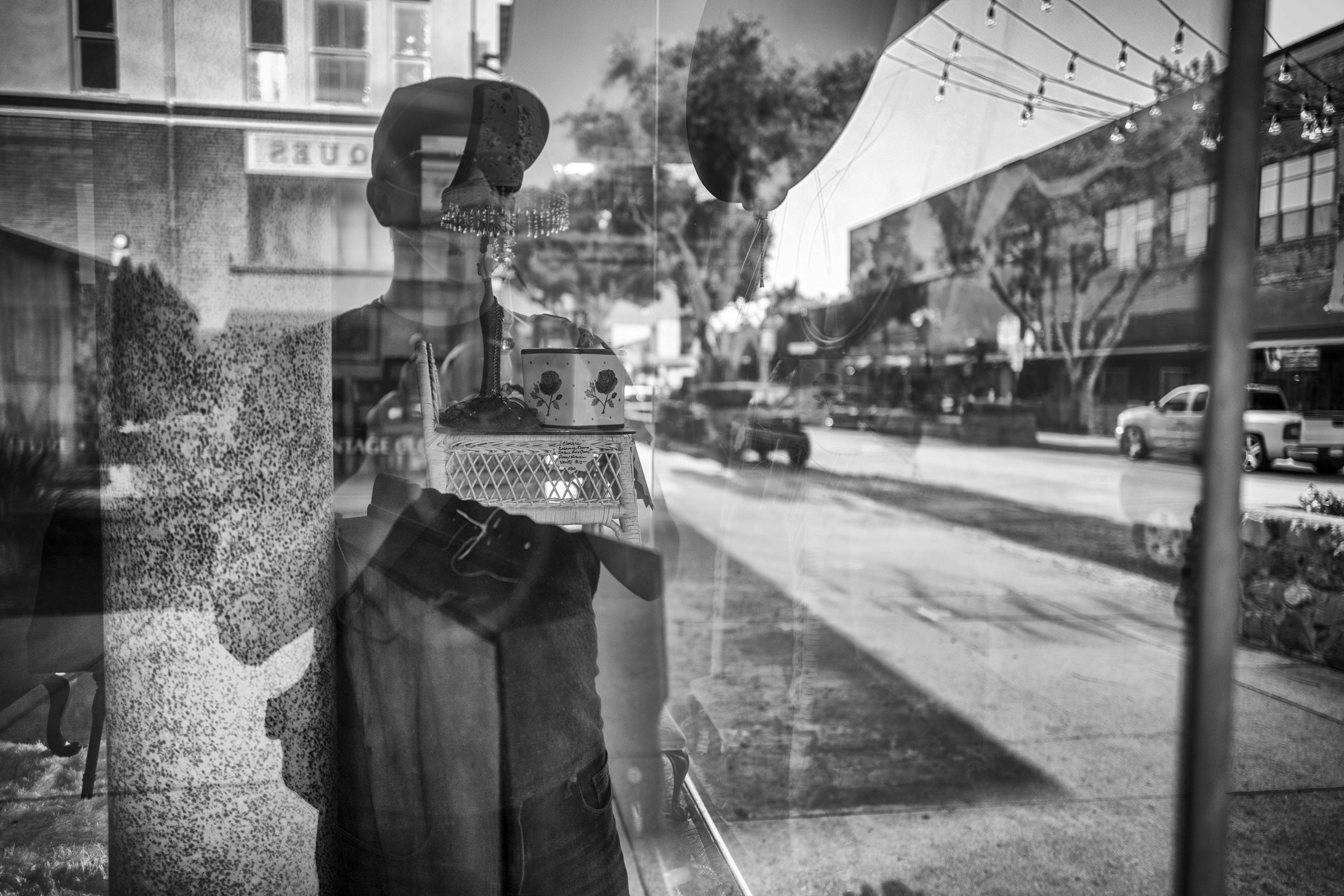 An image of Matt Lara, the photographer, reflected in a window pane.